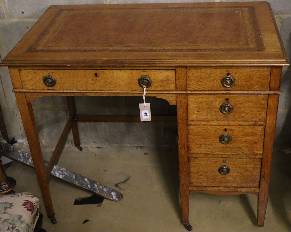 A late Victorian oak kneehole desk, width 90cm depth 53cm height 75cm